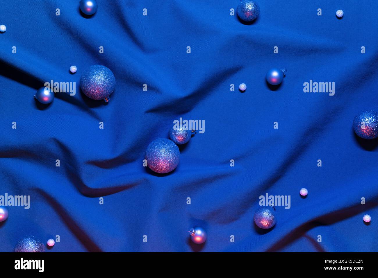 Blue Christmas background with glistening glass balls in neon light Stock Photo