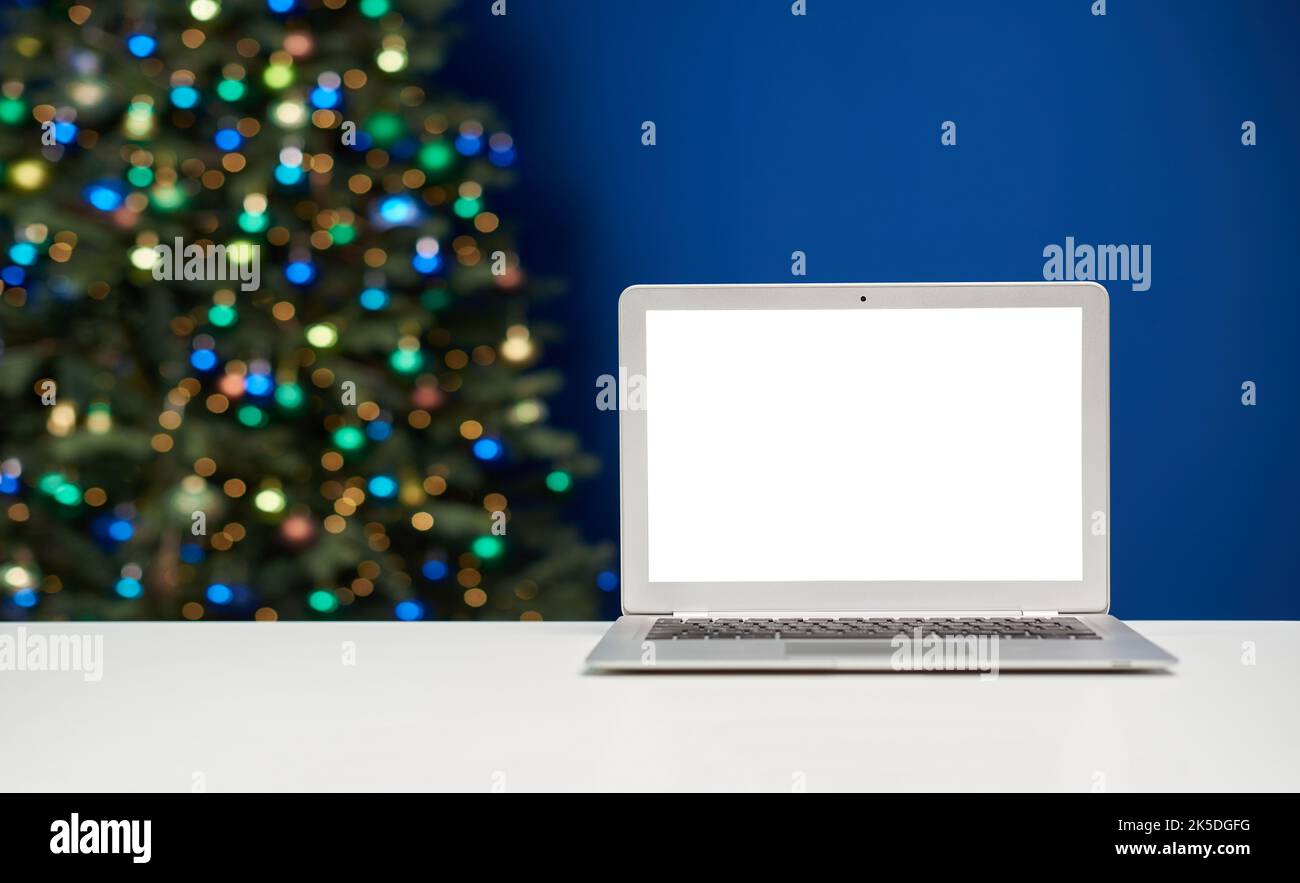 Laptop mockup template with empty screen against christmas lights. Stock Photo