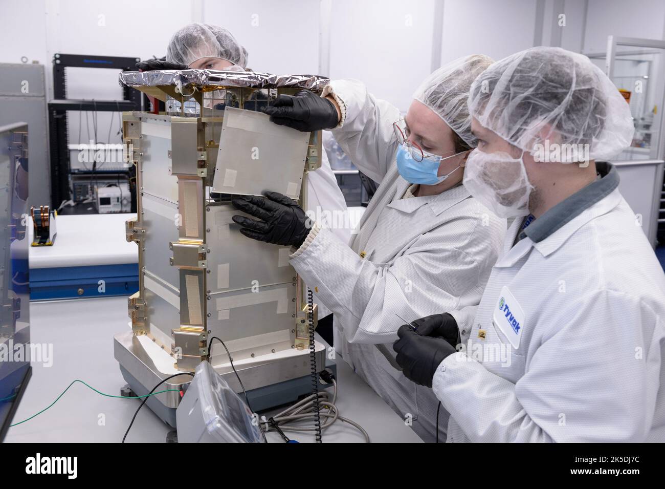 Rebecca Rogers, systems engineer, left, and Dustin Holta, launch engineer, right, mount a cover plate to the CAPSTONE spacecraft dispenser with the spacecraft stowed inside at Tyvak Nano-Satellite Systems, Inc., in Irvine, California. Stock Photo