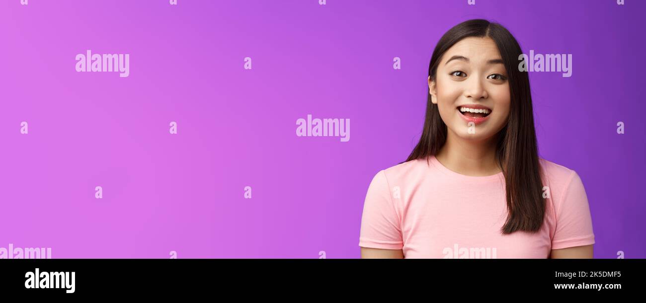 Surprised fascianted cute asian young female raise eyebrows wondered watching amused incredible