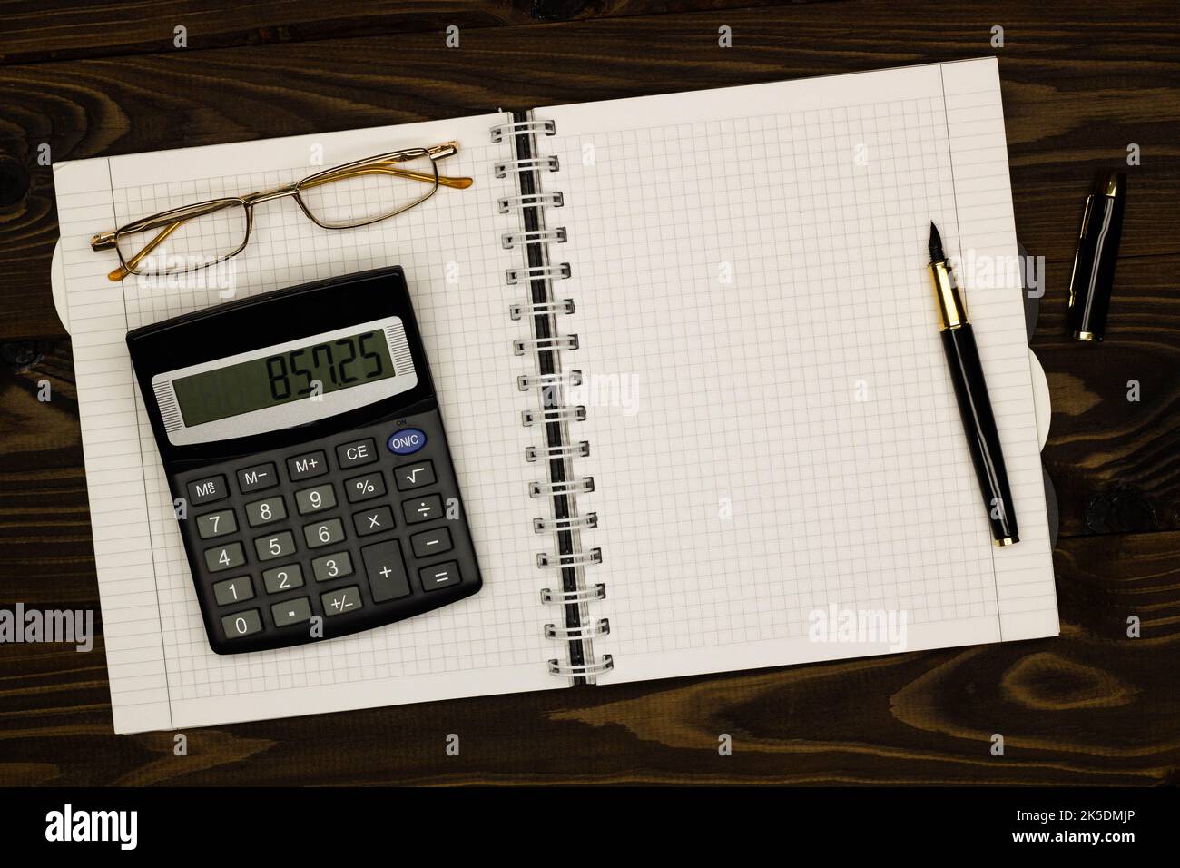 Top view office table desk. Financial report. Flat lay. Workspace with Business office supplies, empty sheet of paper, pen, glasses, calculator Stock Photo