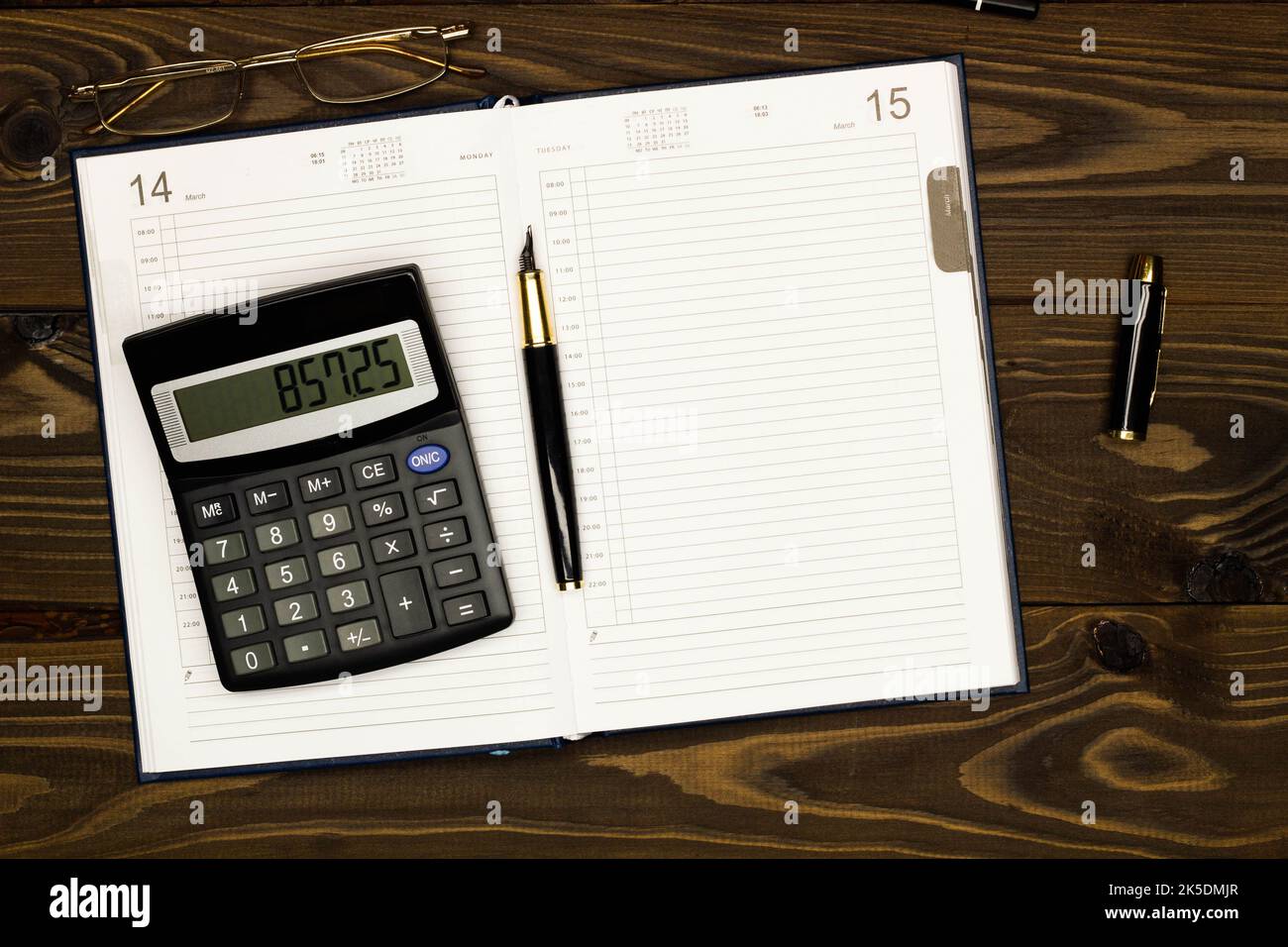 Top view office table desk. Financial report. Flat lay. Workspace with Business office supplies, empty sheet of diary, pen, glasses, calculator Stock Photo