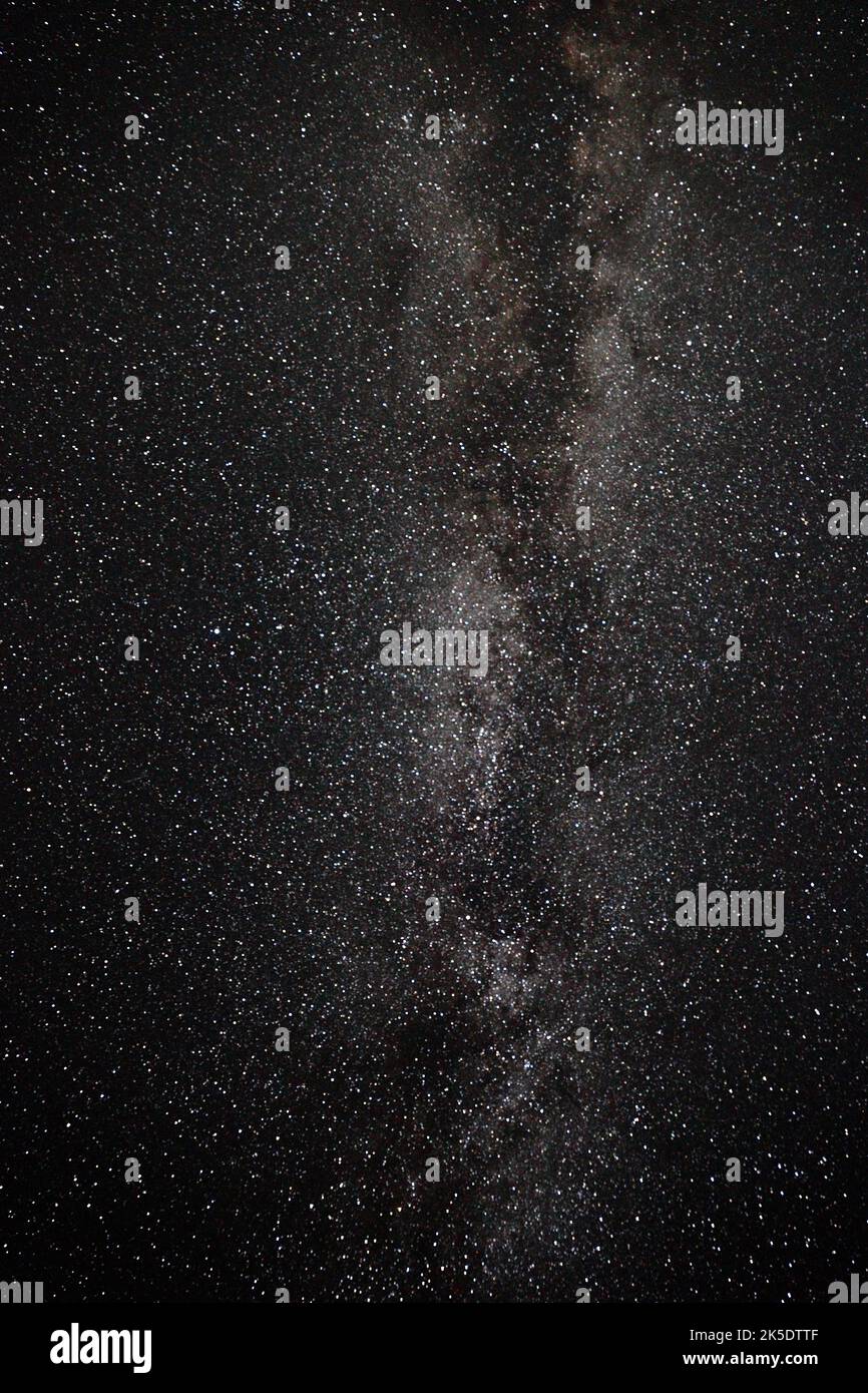 A vertical shot of the magical Milky way constellation in a starry sky ...