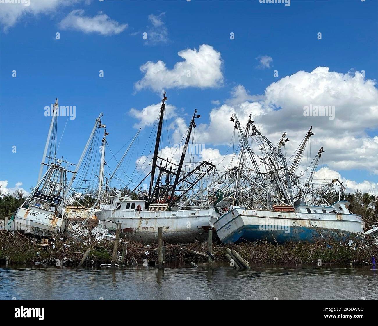 Fort Myers Beach, United States. 05th Oct, 2022. Shrimp trawlers tossed into a pile on land destroyed by the massive Category 4 Hurricane Ian damaging most of the commercial fishing fleet, October 4, 2022 in Fort Myers Beach, Florida. Credit: Mark Rankin/US Army/Alamy Live News Stock Photo