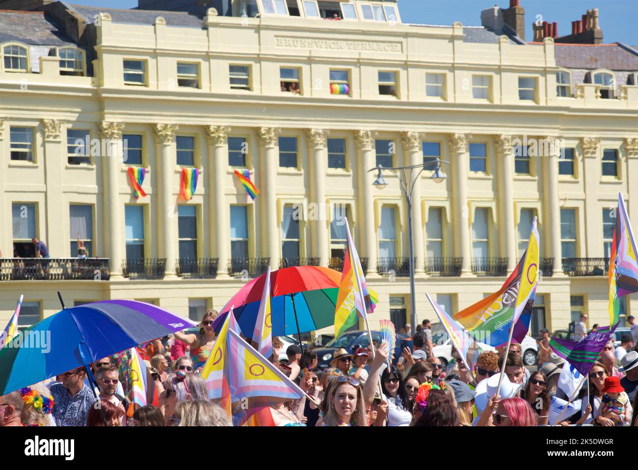 Brighton & Hove Pride Festival, Brighton & Hove, East Sussex, England. Crowds gather on Hove Lawns alongside Brunswick Terrace to watch the beginning of the parade. Stock Photo