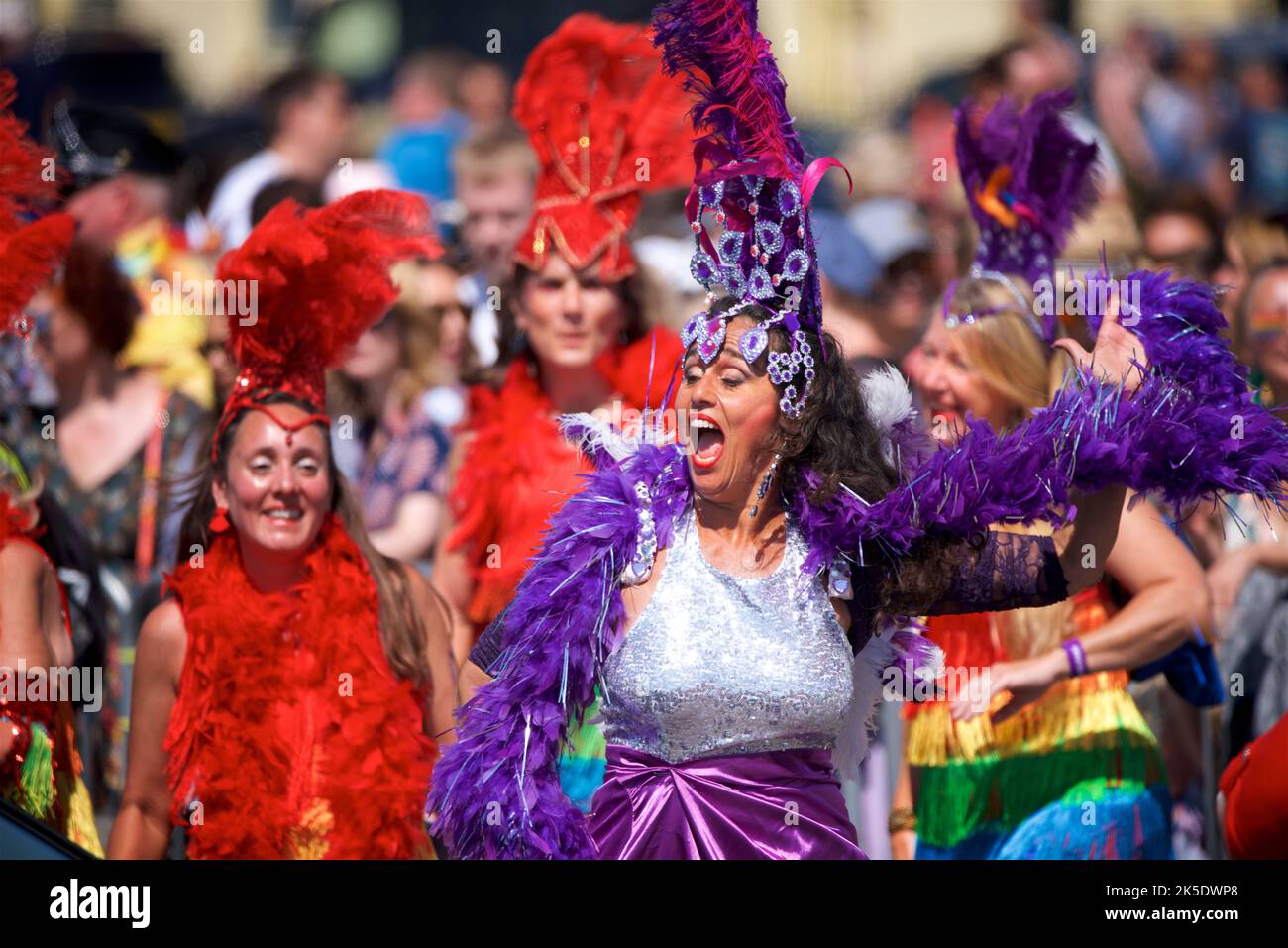 Brighton & Hove Pride Festival, Brighton & Hove, East Sussex, England. Feather-boa dressed dancers in the parade. Stock Photo