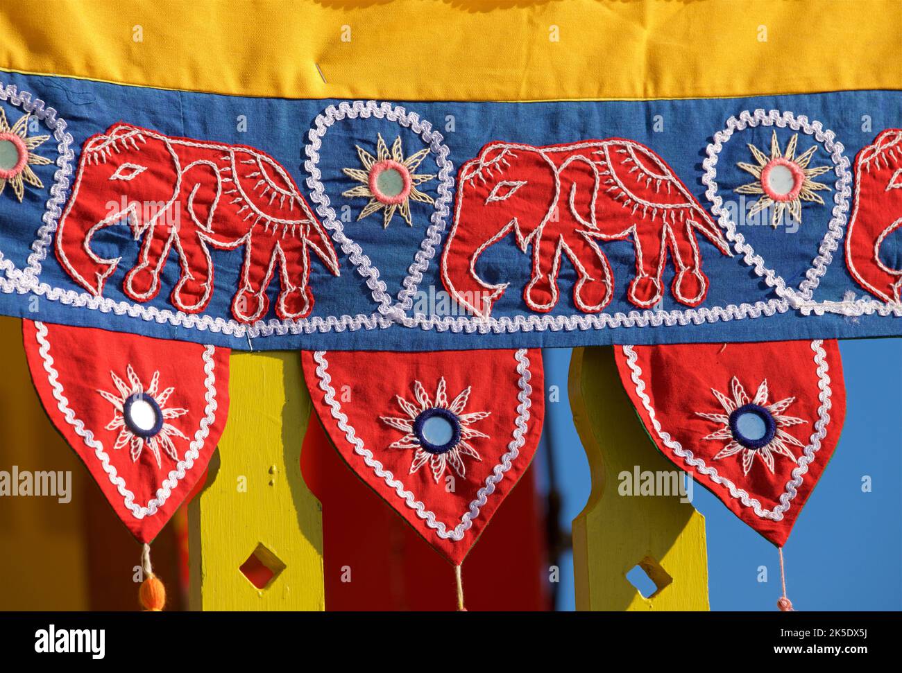 Detail of fabric adornment with elephant designs on the Hare Krishna processional juggernaut, Brighton & Hove, England. The annual Rathayatra Festival for Lord Krishna and his devotees promenades along Hove esplanade each year. Krishna in his form of Jagannatha is pulled along on a large wooden juggernaut. Stock Photo