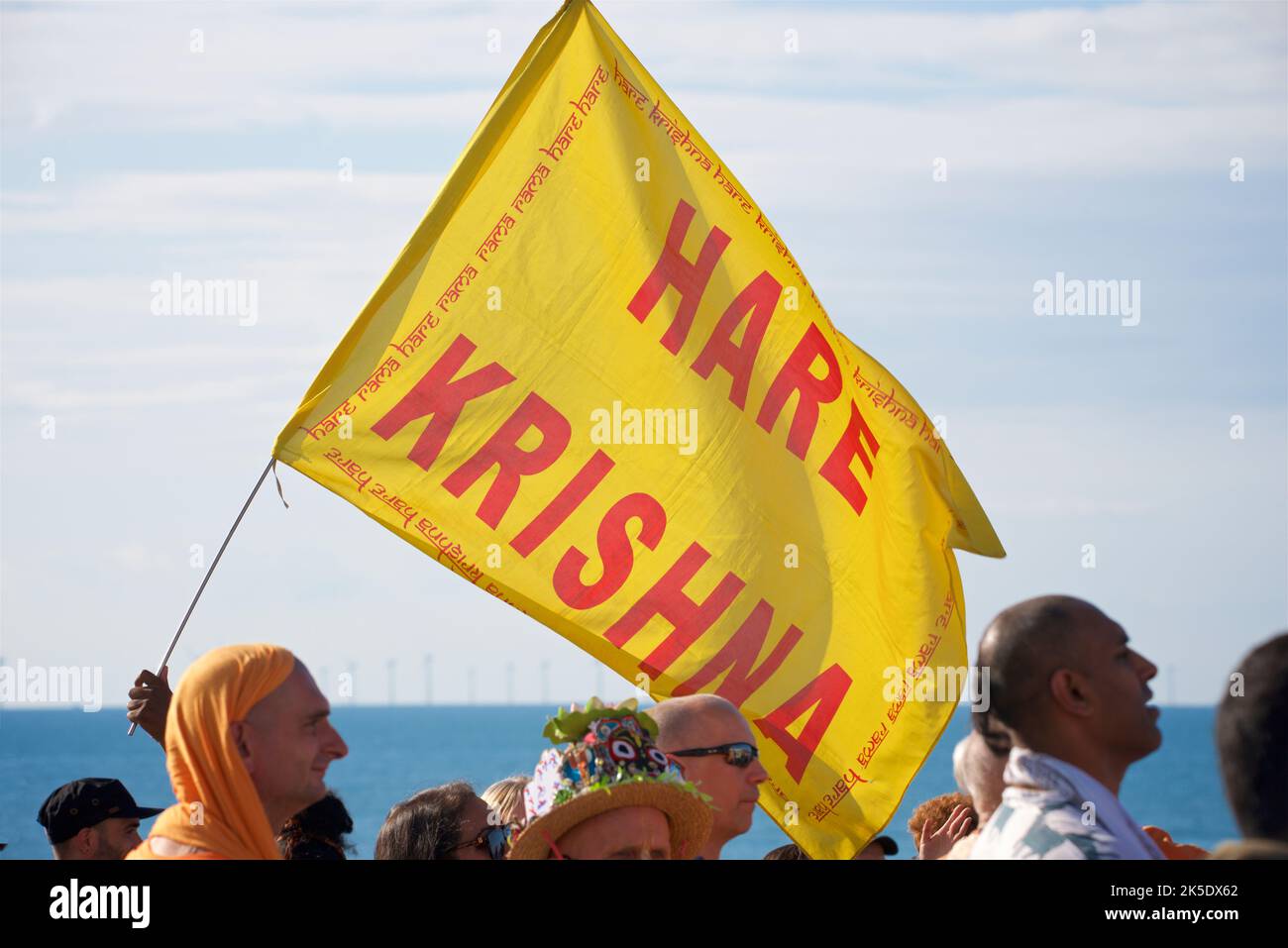 Hare Krishna flag. The annual Rathayatra Festival for Lord Krishna and his devotees promenades along Hove esplanade each year. Krishna in his form of Jagannatha is pulled along on a large wooden juggernaut. Stock Photo