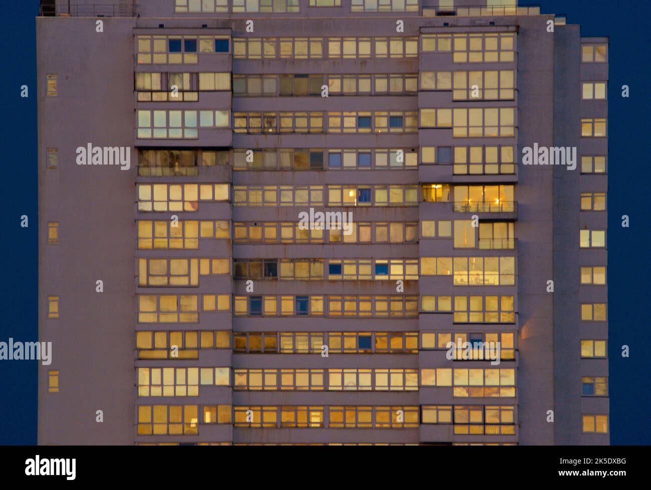 Sussex Heights, a residential tower block in the centre of Brighton, part of the English city of Brighton and Hove. Built between 1966 and 1968 it rises to 334 feet. Here photographed aglow with the windows reflecting the golden light of the setting sun. Stock Photo