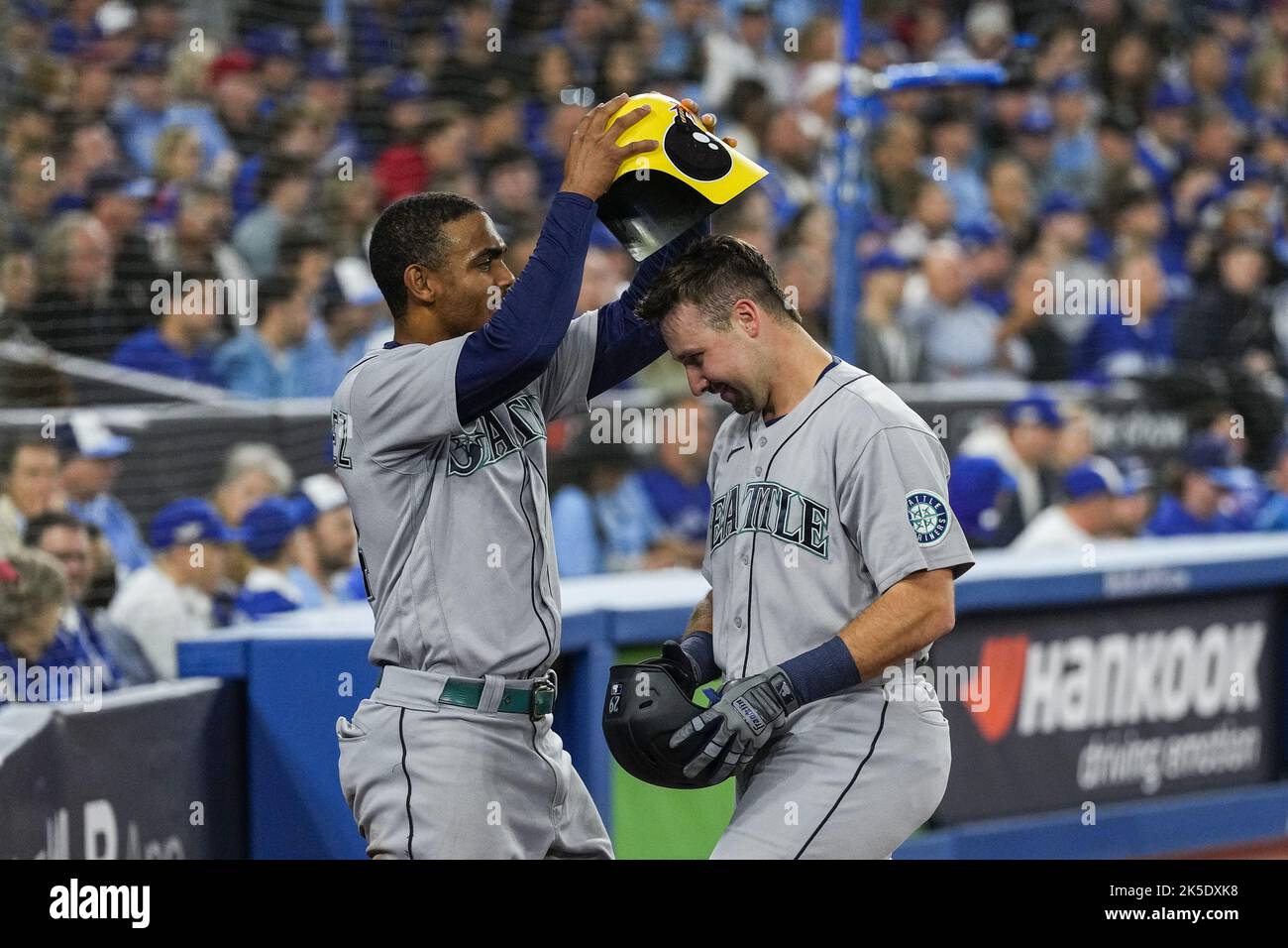Toronto, Canada. 07th Oct, 2022. Seattle Mariners center fielder Julio Rodriguez, left, puts a