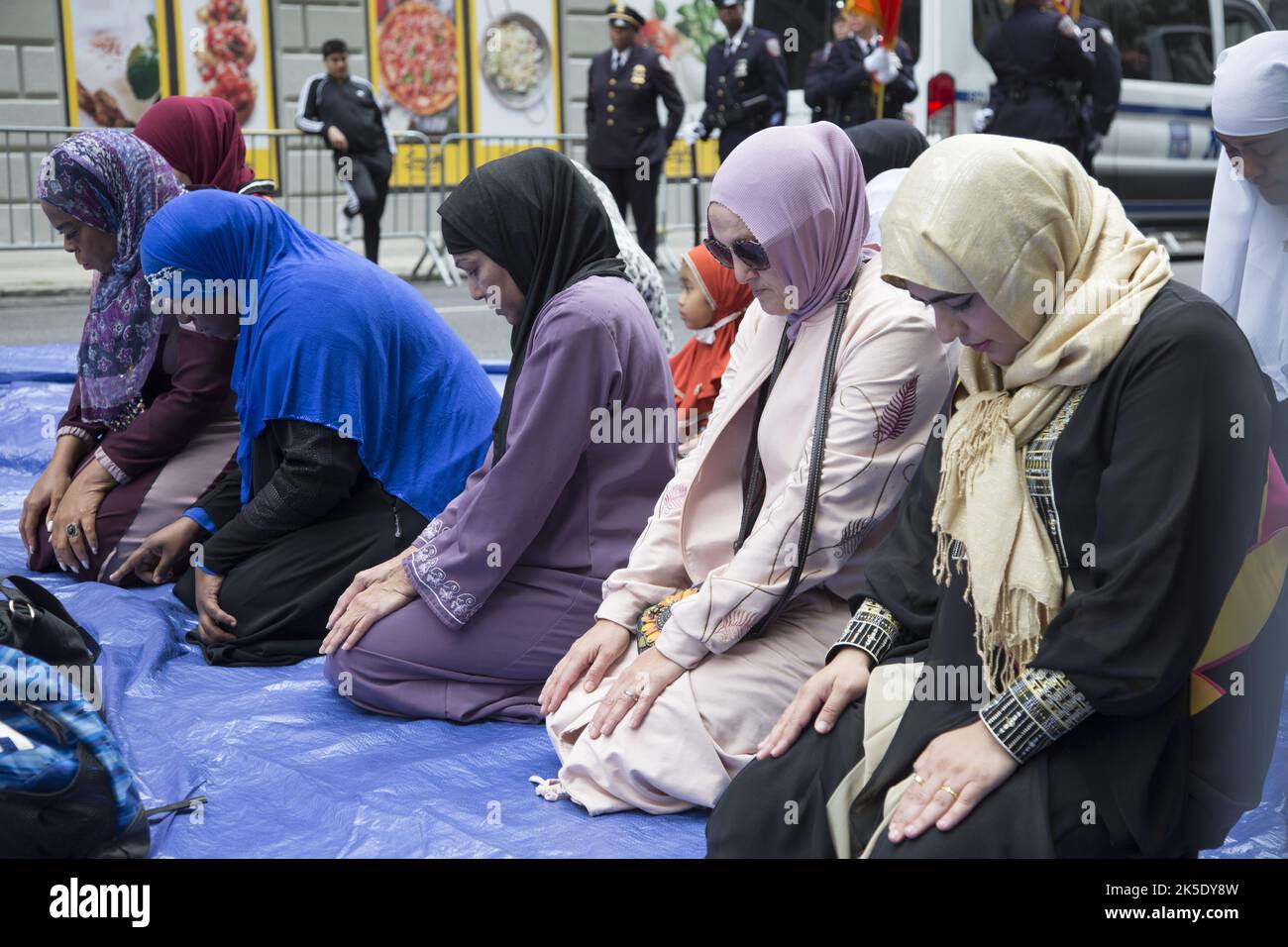 muslim-women-praying-at-the-american-muslim-day-parade-on-madison
