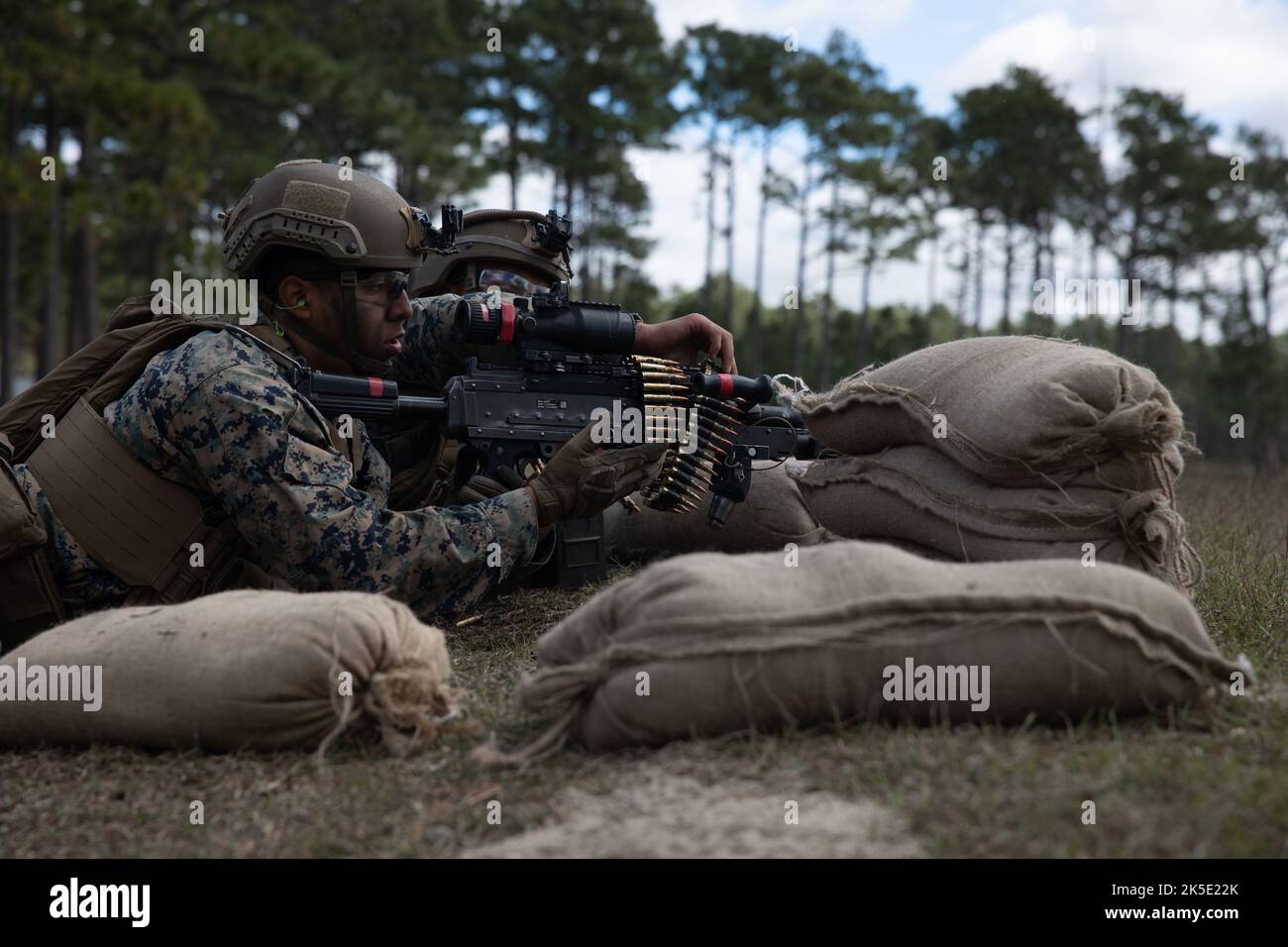 U.S. Marine Corps Cpl. Andy Acasta, a rifleman with 1st Battalion, 6th Marine Regiment, 2d Marine Division, prepares to fire an M240B machine gun during a Marine Corps Combat Readiness Evaluation on Camp Lejeune, North Carolina, Oct. 4, 2022. The purpose of a MCCRE is to formally evaluate the unit’s combat readiness in preparation for deployment. (U.S. Marine Corps photo by Lance Cpl. Aziza Kamuhanda) Stock Photo