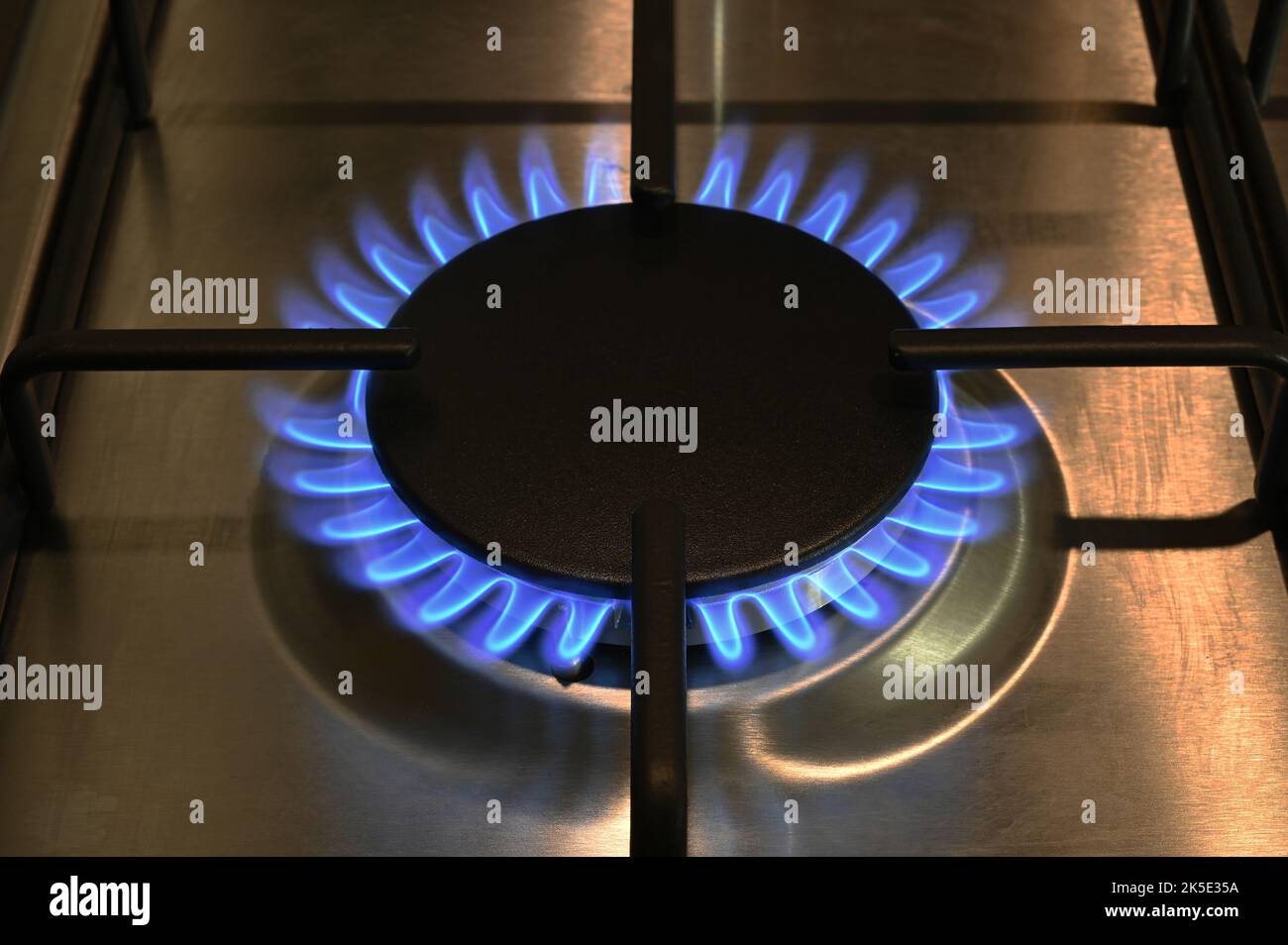 A single ring of a lit gas hob burning with blue flames Stock Photo Alamy