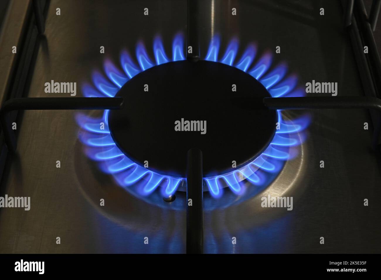 A single ring of a lit gas hob burning with blue flames Stock Photo Alamy