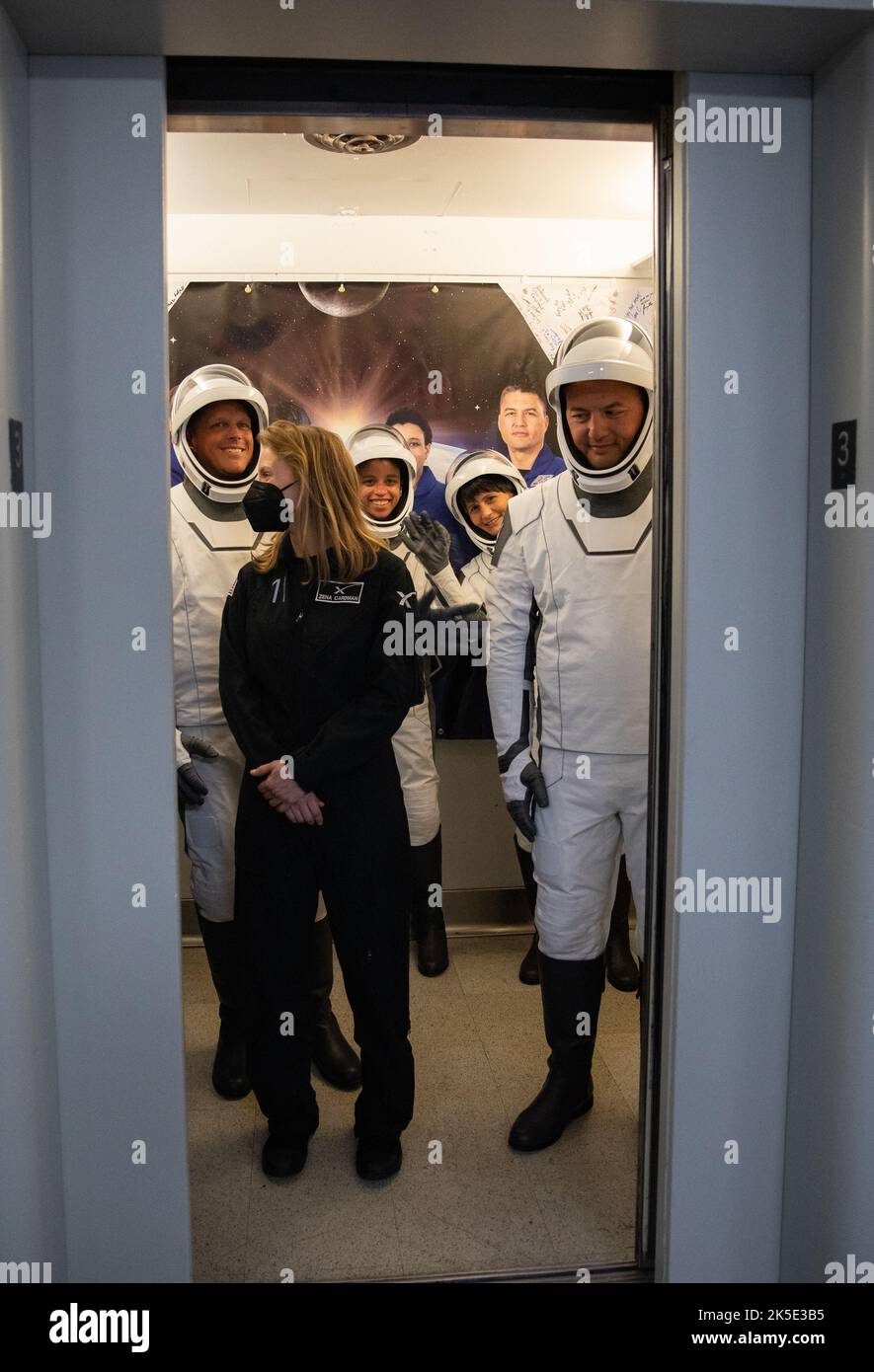 Crew-4 mission astronauts Kjell Lindgren, Bob Hines, Jessica Watson, and Samantha Cristoforetti, enter the elevator in the Astronaut Crew Quarters inside Kennedy Space Center’s Neil A. Armstrong Operations and Checkout Building on April 27, 2022. A team of SpaceX suit technicians assisted the crew as they put on their custom-fitted spacesuits and checked the suits for leaks. The four astronauts will launch aboard SpaceX’s Crew Dragon, powered by the company’s Falcon 9 rocket, to the International Space Station as part of NASA’s Commercial Crew Program. Crew-4 is scheduled to lift off today at Stock Photo
