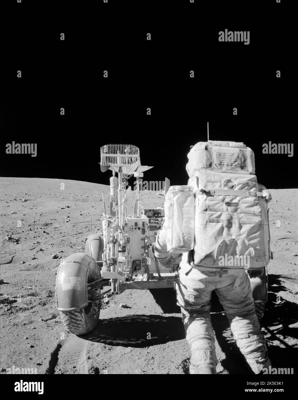 Apollo 16 lunar mission. This photograph, taken during the mission's second extravehicular activity, shows astronaut John W. Young retrieving tools from the Lunar Roving Vehicle's Hand Tool Carrier. NASA's Marshall Space Flight Center designed, developed and managed the production of the lunar rover and the Saturn V rocket that took astronauts to the moon. April 20, 1972. A unique optimised NASA image (with added black vertical space above original square image): Credit: NASA  An optimised NASA image: Credit: NASA Stock Photo