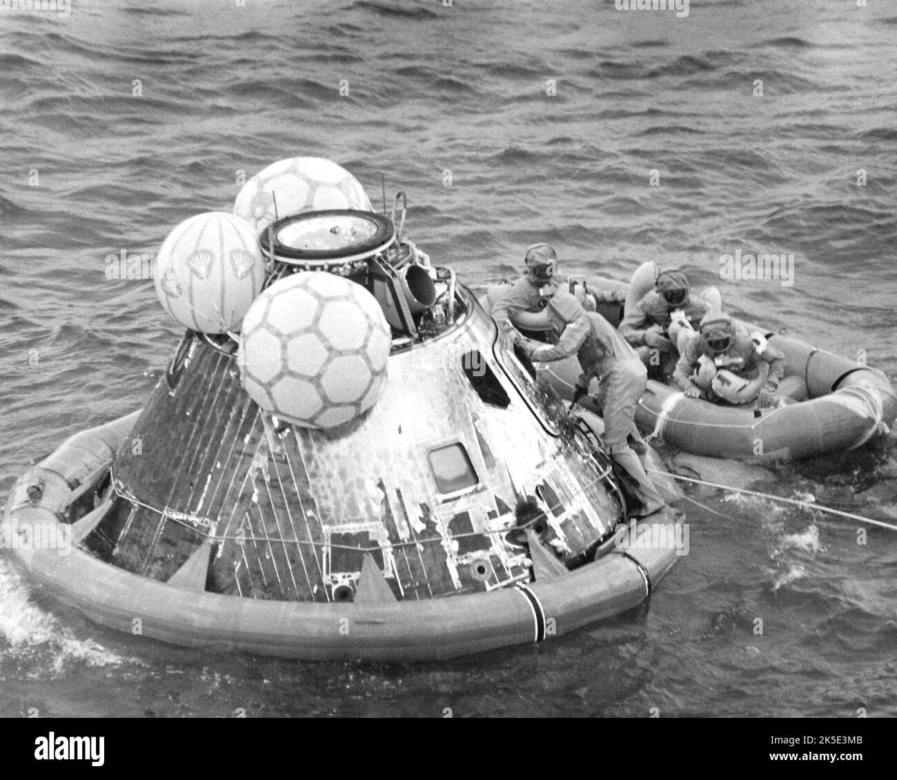 On 24 July 1969 the Apollo 11 crew successfully returned to Earth following their 8-day mission to the lunar surface. Astronauts Neil Armstrong, Edwin 'Buzz' Aldrin and Michael Collins splashed down in the Pacific Ocean, 13 miles from recovery ship USS Hornet. Donning biological isolation garments before leaving the spacecraft, the crew went directly into the Mobile Quarantine Facility on the aircraft carrier, their home for the next 21 days. With the success of Apollo 11, the national objective of landing men on the Moon and returning them safely was accomplished.  NASA image / Credit: NASA Stock Photo