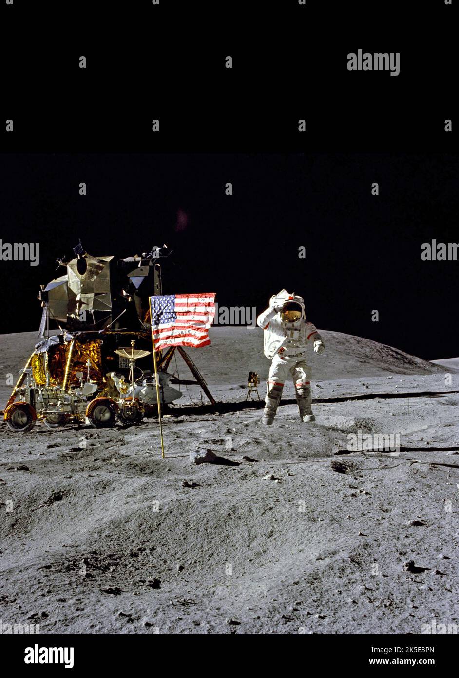 Apollo 16 moonwalk. Astronaut John Young salutes the U.S. flag at the Descartes landing site during the first Apollo 16 extravehicular activity (EVA-1). Young, commander of the Apollo 16 lunar landing mission, jumps up from the lunar surface as astronaut and Air Force veteran, Charles M. Duke Jr., lunar module pilot, took this picture. A unique optimised NASA image (with added black vertical space above original square image): Credit: NASA Stock Photo