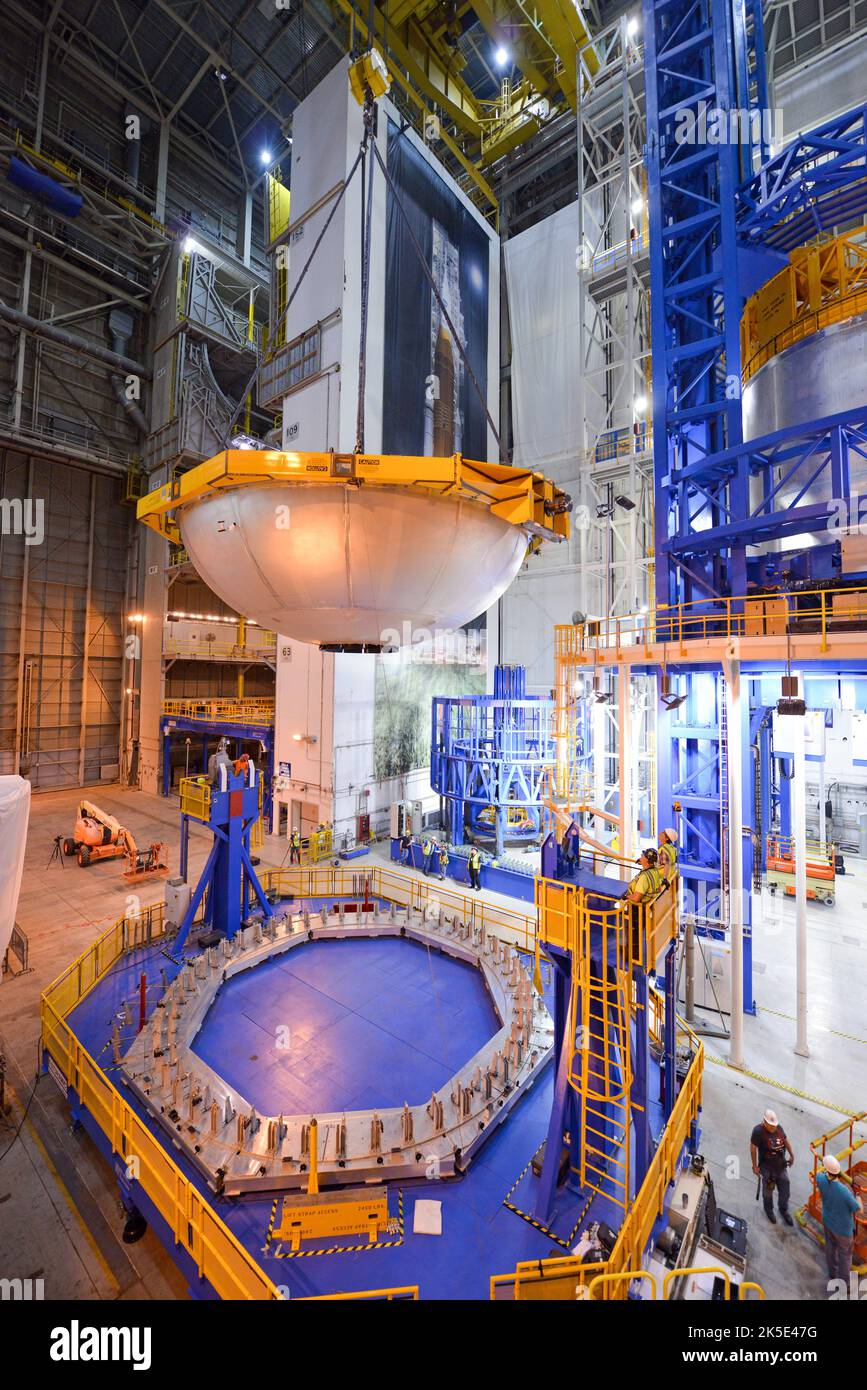 NASA cleared the dome, shown here being removed from the infeeder tool, for use as intended as the bottom dome of the liquid oxygen tank structural test article being welded in the Vertical Assembly Center, right. The dome sustained minor damage during operations May 3, 2017. The investigation team is currently wrapping up their investigation of the mishap and will prepare recommendations to the SLS program. An optimised version of an original NASA image. Credit: NASA/ JGuidry Stock Photo