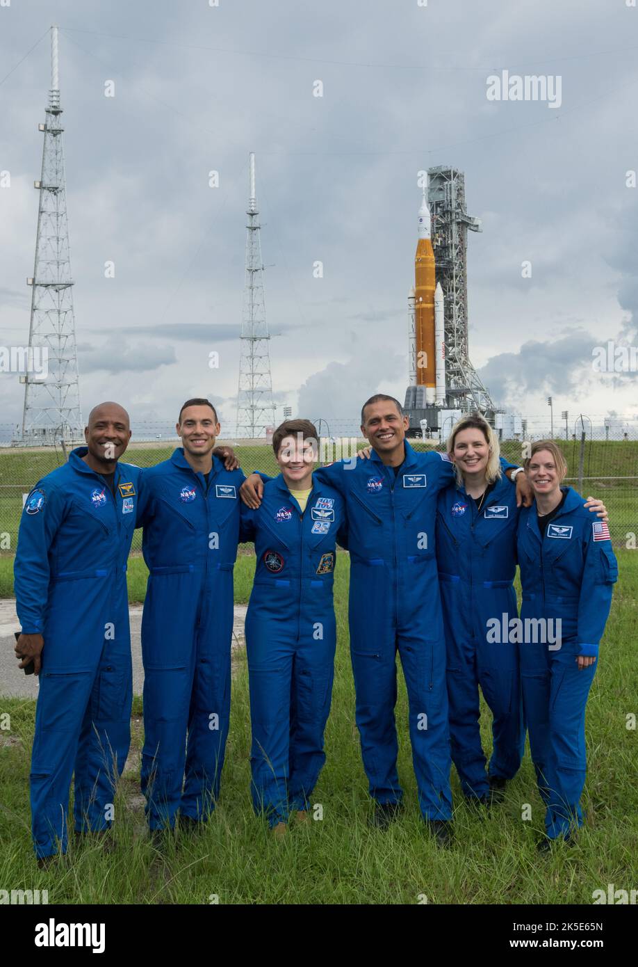 NASA astronauts and astronaut candidates pose for a photograph in front of NASA’s Artemis I Space Launch System and Orion spacecraft atop the mobile launcher on the pad at Launch Complex 39B at the agency’s Kennedy Space Center in Florida on Sept. 2, 2022. The astronauts are, from left to right: Victor Glover, NASA astronaut; Marcos Berrios, NASA astronaut candidate; Anne McClain, NASA astronaut; Anil Menon and Deniz Burnham, NASA astronaut candidates; and Zena Cardman, NASA astronaut. The first in a series of increasingly complex missions, Artemis I will provide a foundation for human deep sp Stock Photo