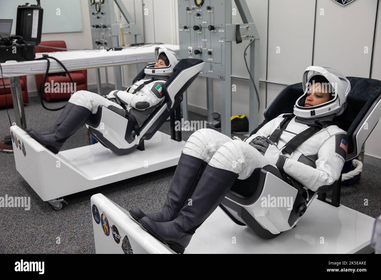 Crew-4 mission astronauts Samantha Cristoforetti, left, and Jessica Watkins relax in the suit room in the Astronaut Crew Quarters inside Kennedy Space Center’s Neil A. Armstrong Operations and Checkout Building on April 27, 2022. A team of SpaceX suit technicians assisted the crew as they put on their custom-fitted spacesuits and checked the suits for leaks. Astronauts Kjell Lindgren and Bob Hines will join Cristoforetti and Watkins aboard SpaceX’s Crew Dragon, powered by the company’s Falcon 9 rocket, which will carry the four-person crew to the International Space Station as part of NASA’s C Stock Photo