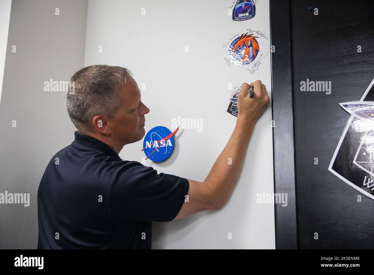 Crew-4 mission astronaut Bob Hines signs the mission patch in the Astronaut Crew Quarters inside Kennedy Space Center’s Neil A. Armstrong Operations and Checkout Building on April 27, 2022. Hines, along with Kjell Lindgren, Jessica Watkins, and Samantha Cristoforetti, will launch aboard SpaceX’s Crew Dragon – powered by the company’s Falcon 9 rocket – to the International Space Station as part of NASA’s Commercial Crew Program. Crew-4 is scheduled to lift off today at 3:52 a.m. EDT from Launch Complex 39A at Kennedy. Stock Photo