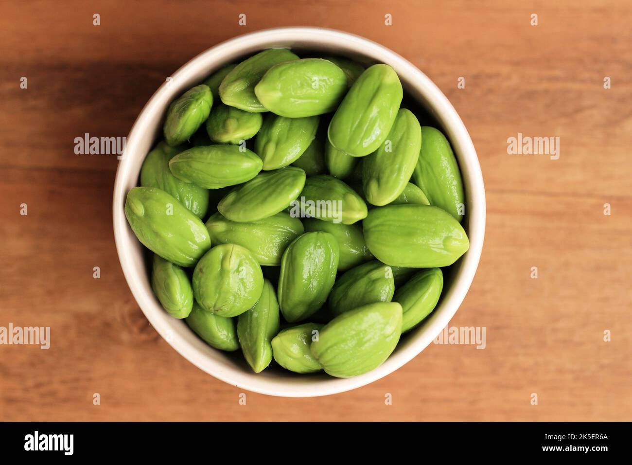 Raw Peeled  Pete Petai  or Parkia speciosa in a Bowl. Petai Popular Stinky Bitter Bean from Indonesia and Thailand Stock Photo
