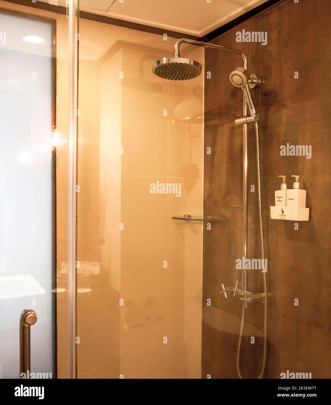 A shower stall with a glass door in a resort in Thailand. Stock Photo