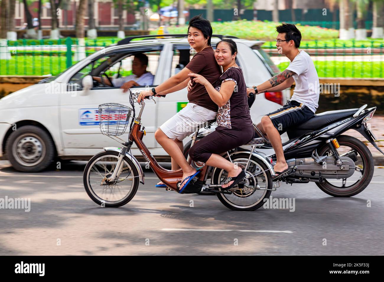 Girls riding electric bicycle in traffic, Hai Phong, Vietnam Stock ...