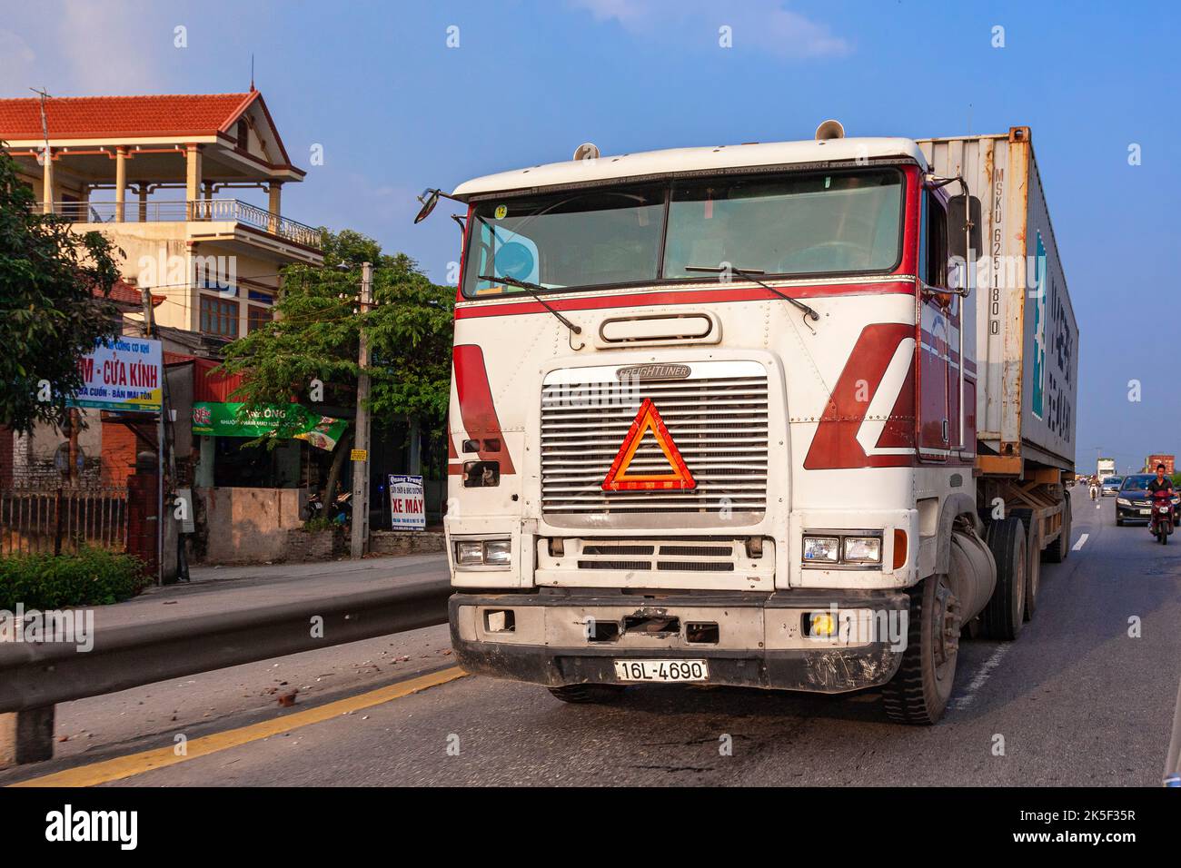 Vietnamese container truck on highway from Hai Phong to Hanoi, Vietnam Stock Photo