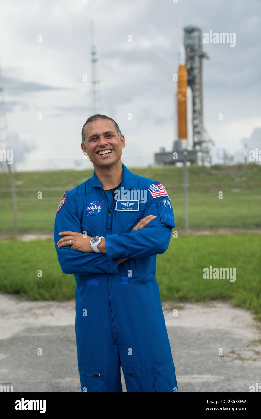 NASA astronaut candidate Anil Menon poses for a photograph in front of NASA’s Artemis I Space Launch System and Orion spacecraft atop the mobile launcher on the pad at Launch Complex 39B at the agency’s Kennedy Space Center in Florida on Sept. 2, 2022. The first in a series of increasingly complex missions, Artemis I will provide a foundation for human deep space exploration and demonstrate our commitment and capability to extend human presence to the Moon and beyond. The primary goal of Artemis I is to thoroughly test the integrated systems before crewed missions by operating the spacecraft i Stock Photo