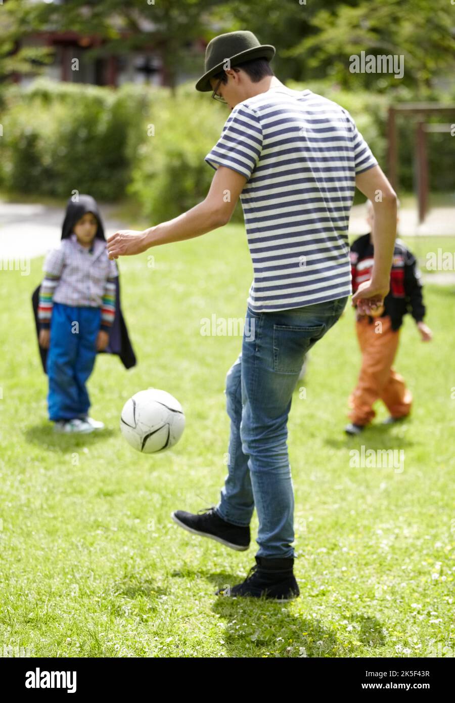 Sport is great for kids and adults alike. Young guy playing football