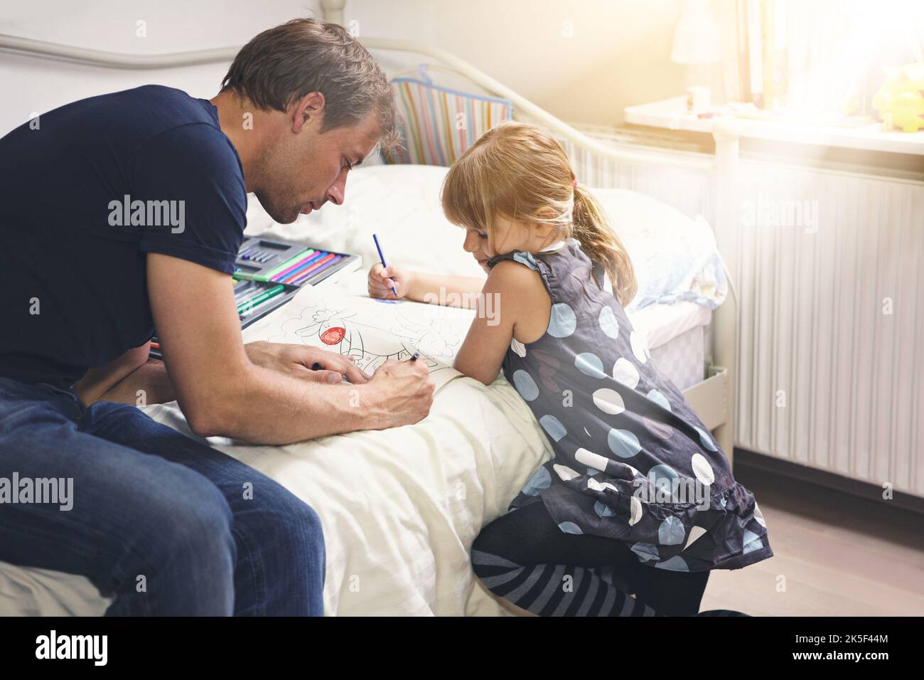 Setting aside time to spend with his daughter a single dad coloring in