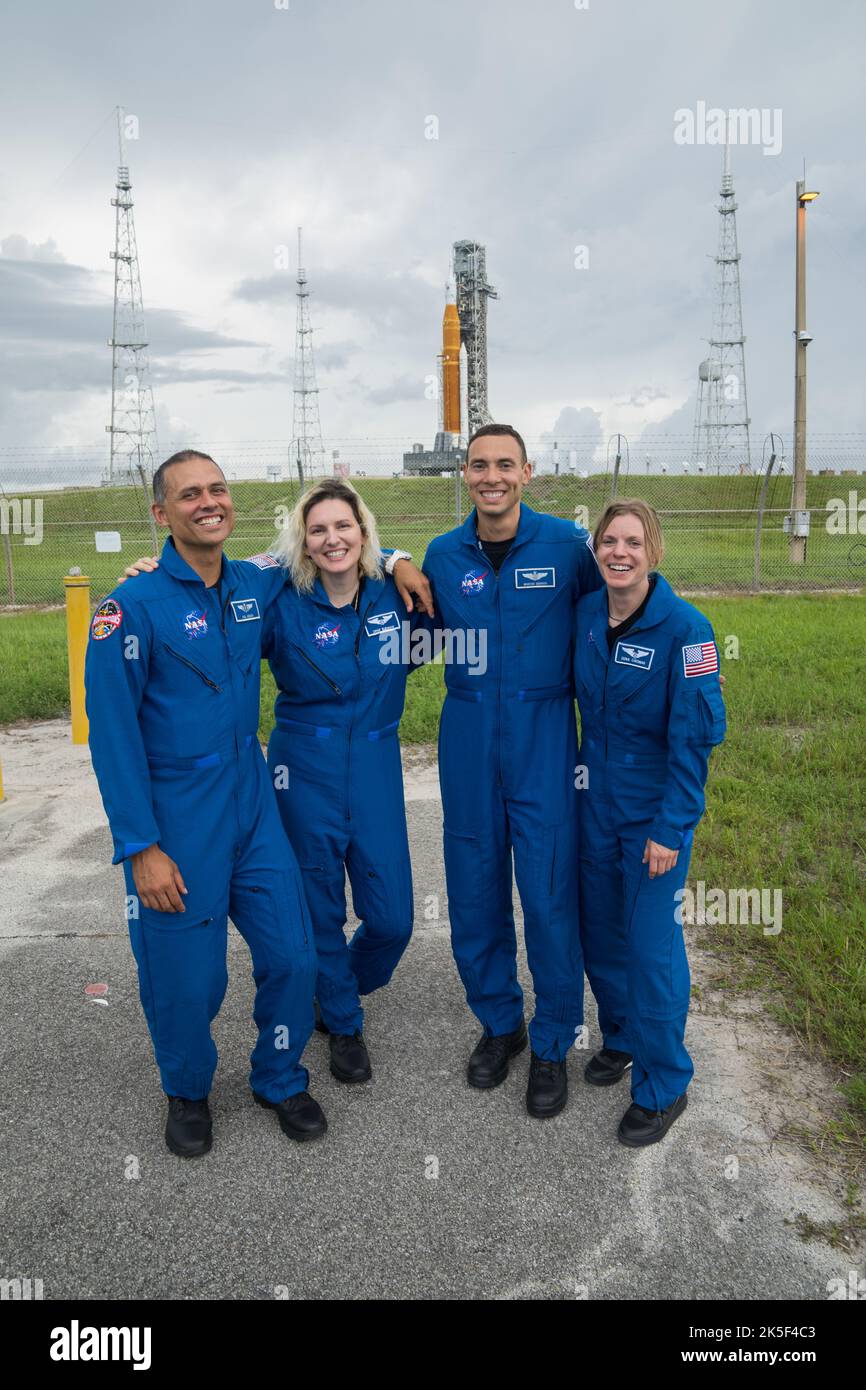 From left to right, NASA astronaut candidates Anil Menon, Deniz Burnham, and Marcos Berrios, and NASA astronaut Zena Cardman pose for a photograph in front of NASA’s Artemis I Space Launch System and Orion spacecraft atop the mobile launcher on the pad at Launch Complex 39B at the agency’s Kennedy Space Center in Florida on Sept. 2, 2022. The first in a series of increasingly complex missions, Artemis I will provide a foundation for human deep space exploration and demonstrate our commitment and capability to extend human presence to the Moon and beyond. The primary goal of Artemis I is to tho Stock Photo