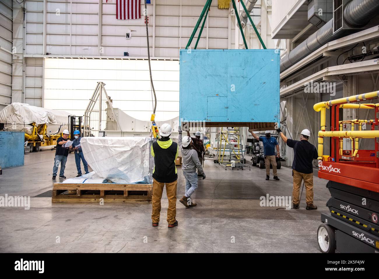 Technicians remove the United Launch Alliance (ULA) Atlas V boattail