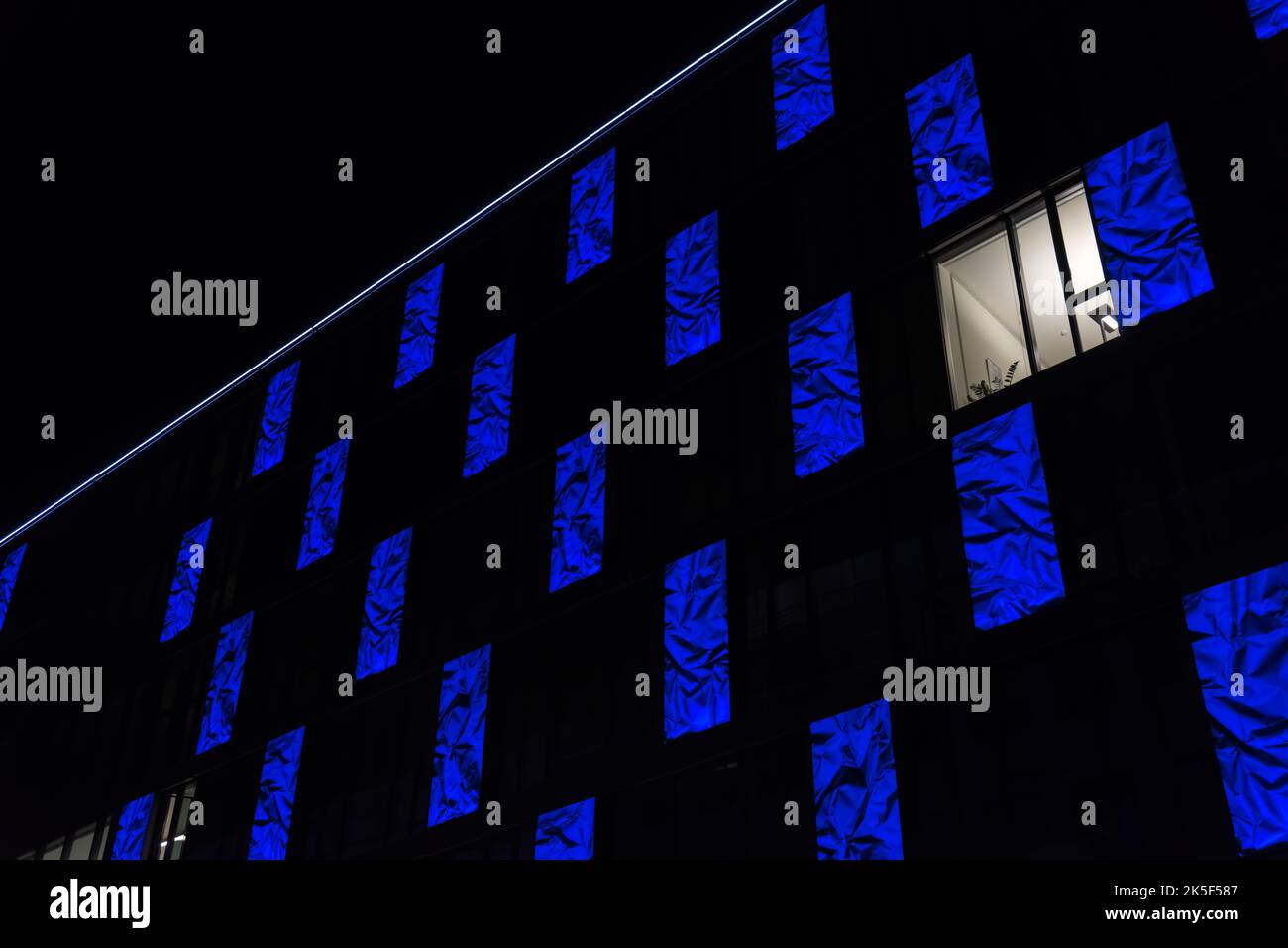 A bright window on a blue facade Stock Photo