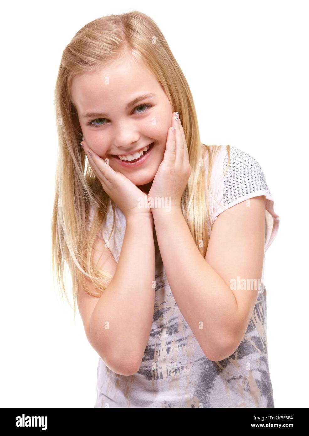 Still a sweet kid. Sweet young girl posing for the camera in a white studio. Stock Photo