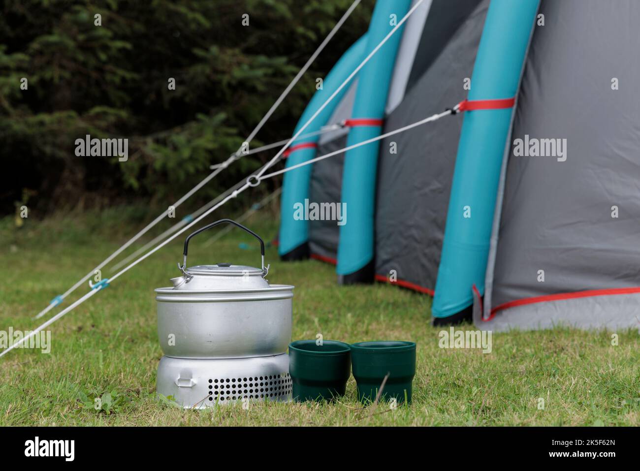 Camp stove, cups and tent. Stock Photo