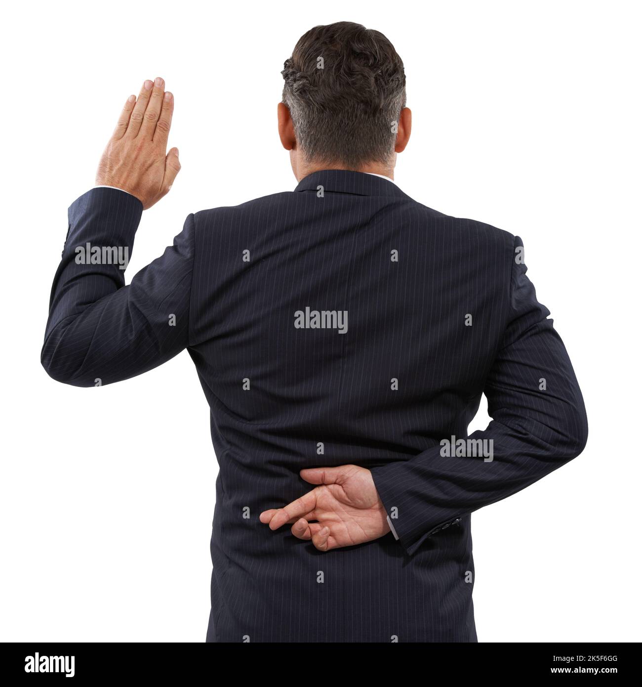 Dishonest oath. Rearview of a mature man swearing an oath with his fingers crossed behind his back. Stock Photo