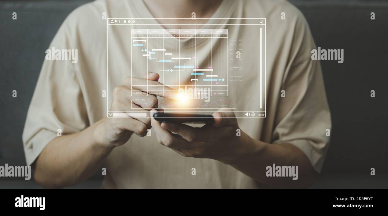 Analyst working with computer in Startup business concept. Businessman touching tablet with hologram of Data management system statistics and analytic Stock Photo