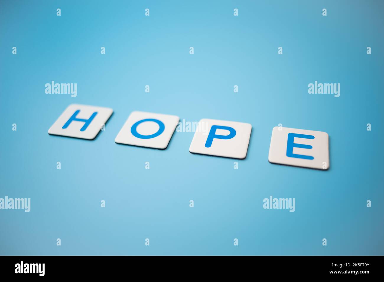 Word HOPE on blue background Stock Photo