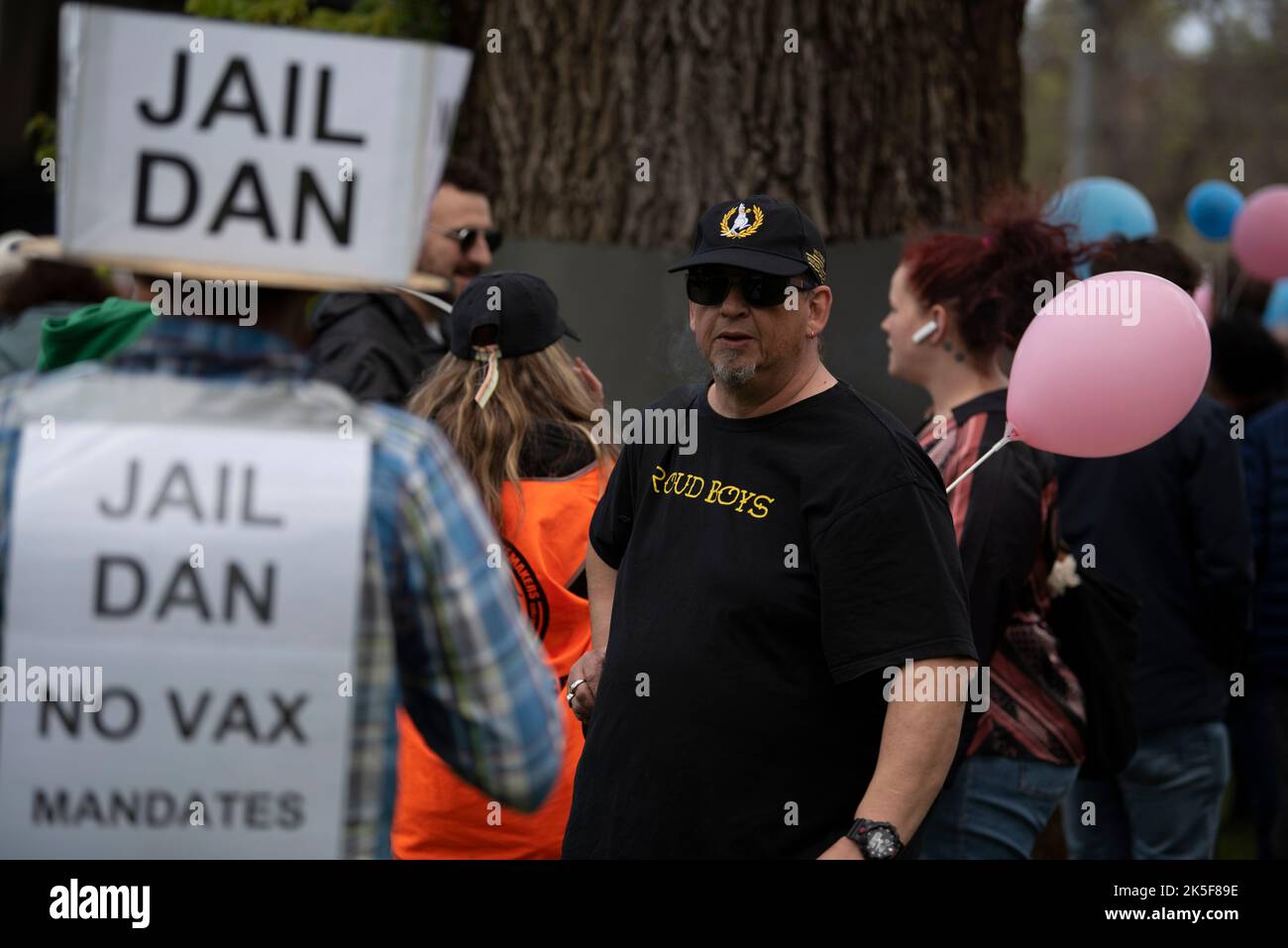 October 8th, 2022, Melbourne, Australia. A Proud Boy holding a pink balloon at Bernie Finn's March for the Babies, in the foreground is an anti-vax protester. Credit: Jay Kogler/Alamy Live News Stock Photo