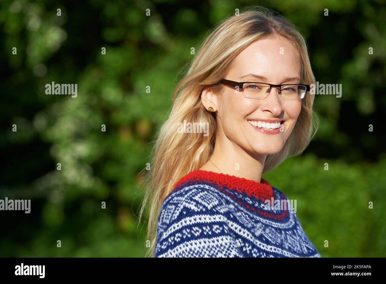 She loves winter time. an attractive young woman enjoying a day outside. Stock Photo