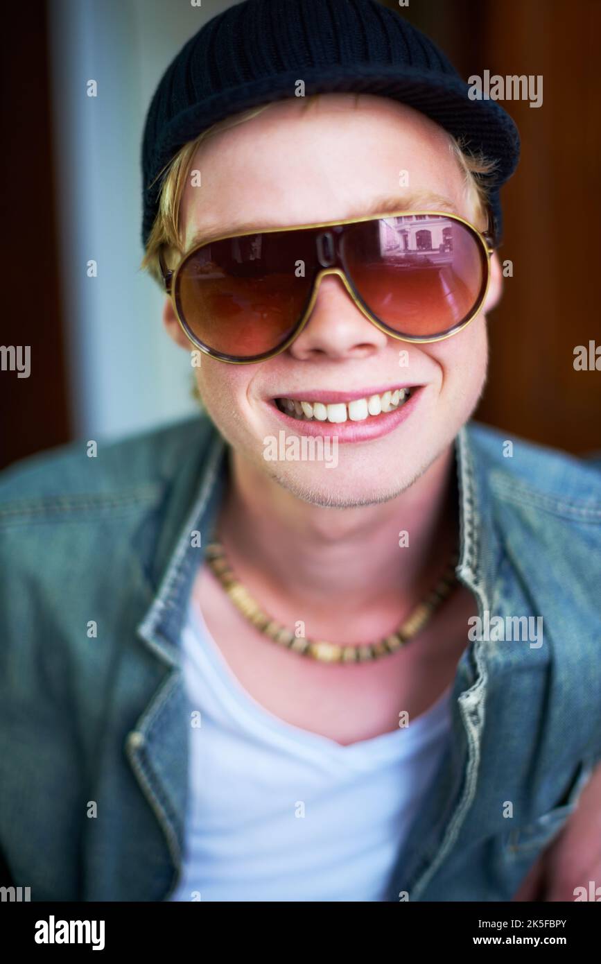 Hes not afraid to give you a smile. Young guy in urban clothing giving ...