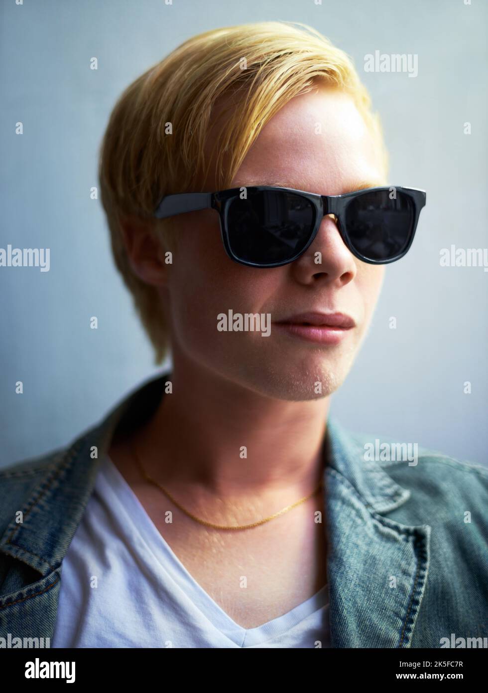 Too cool. Portrait of an attractive young guy wearing hipster shades. Stock Photo