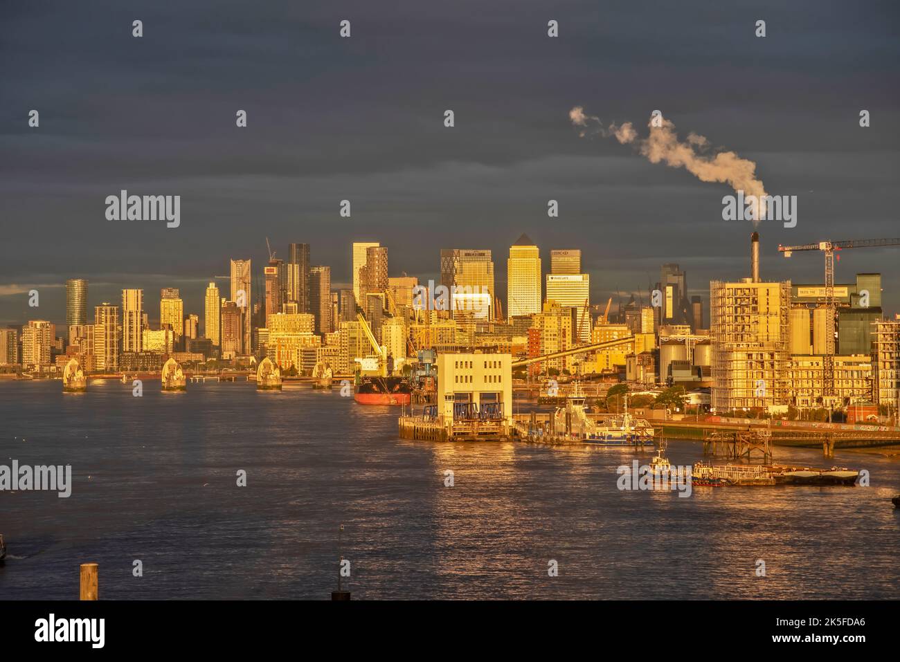 Golden autumn sunrise of Canary Wharf London overlooking the River Thames. Stock Photo