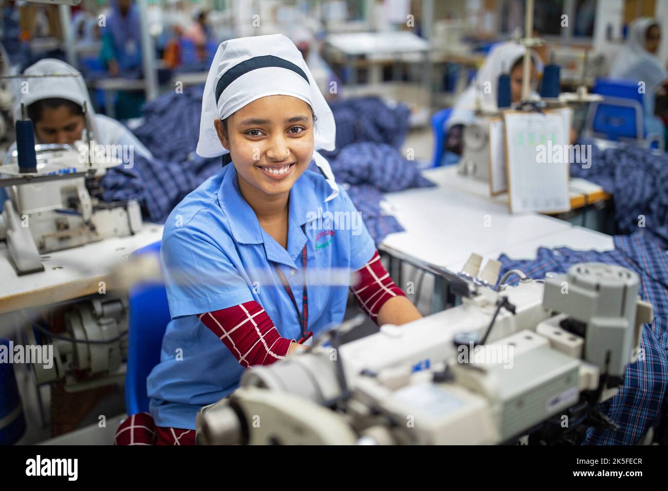 A garment worker works in a readymade garment factory. The ready-made garment (RMG) industry is a mainstay of this economic success story. Stock Photo