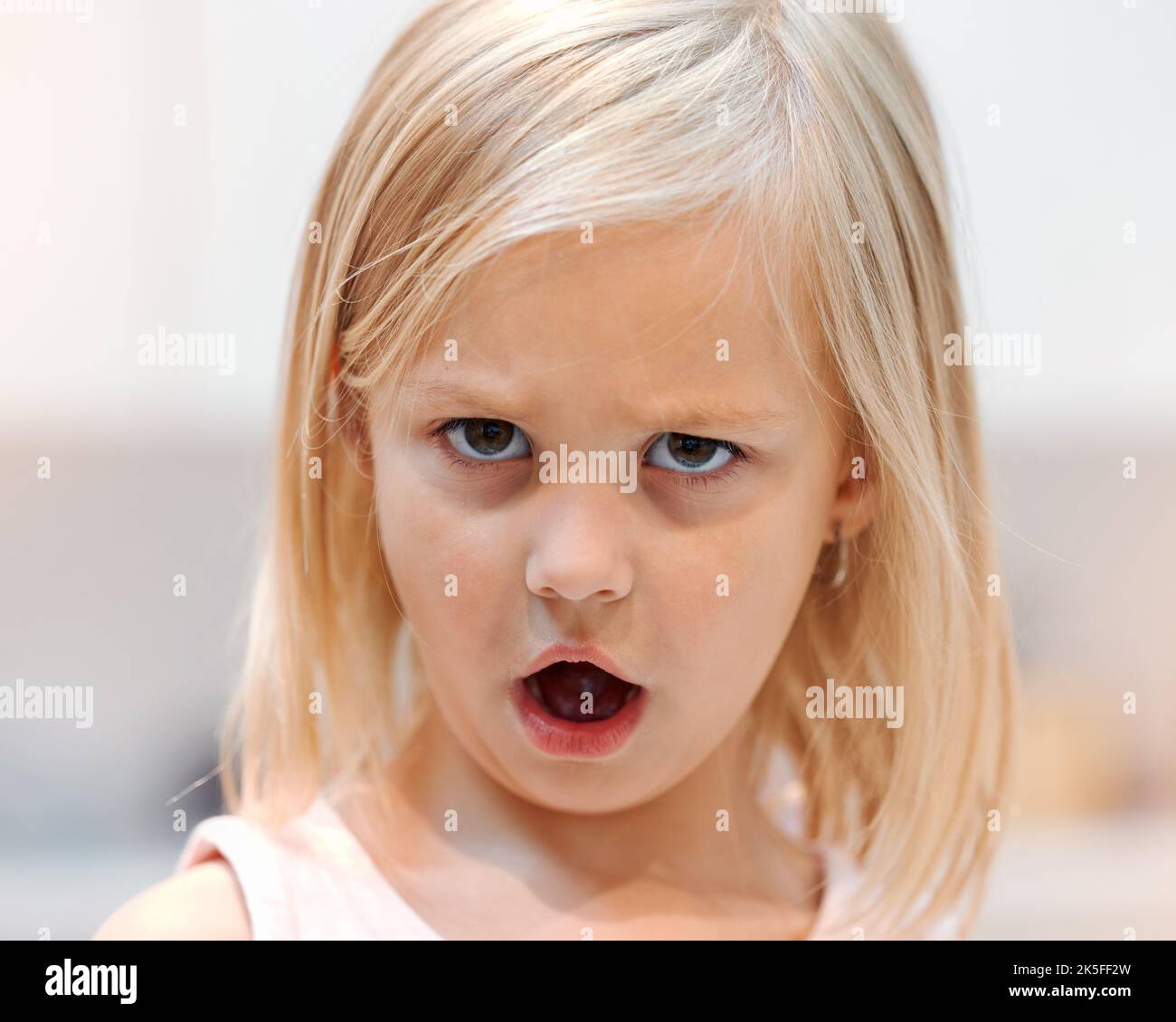 Angry, little girl and tantrum face portrait reaction to shock of rejection and disappointment. Unhappy, frustrated and moody female child with bad Stock Photo
