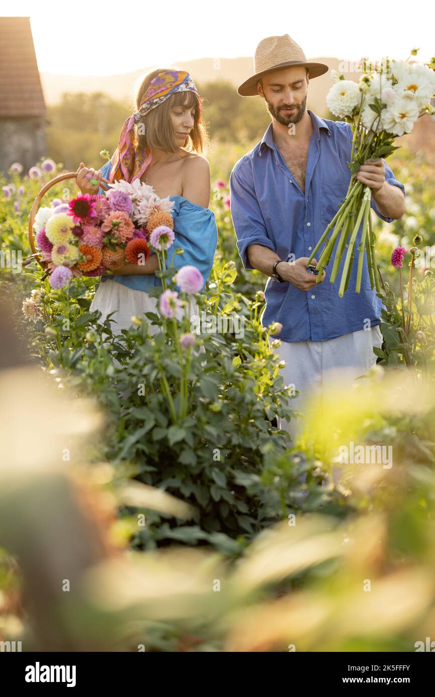 Man and woman pick up flowers at farm outdoors Stock Photo Alamy