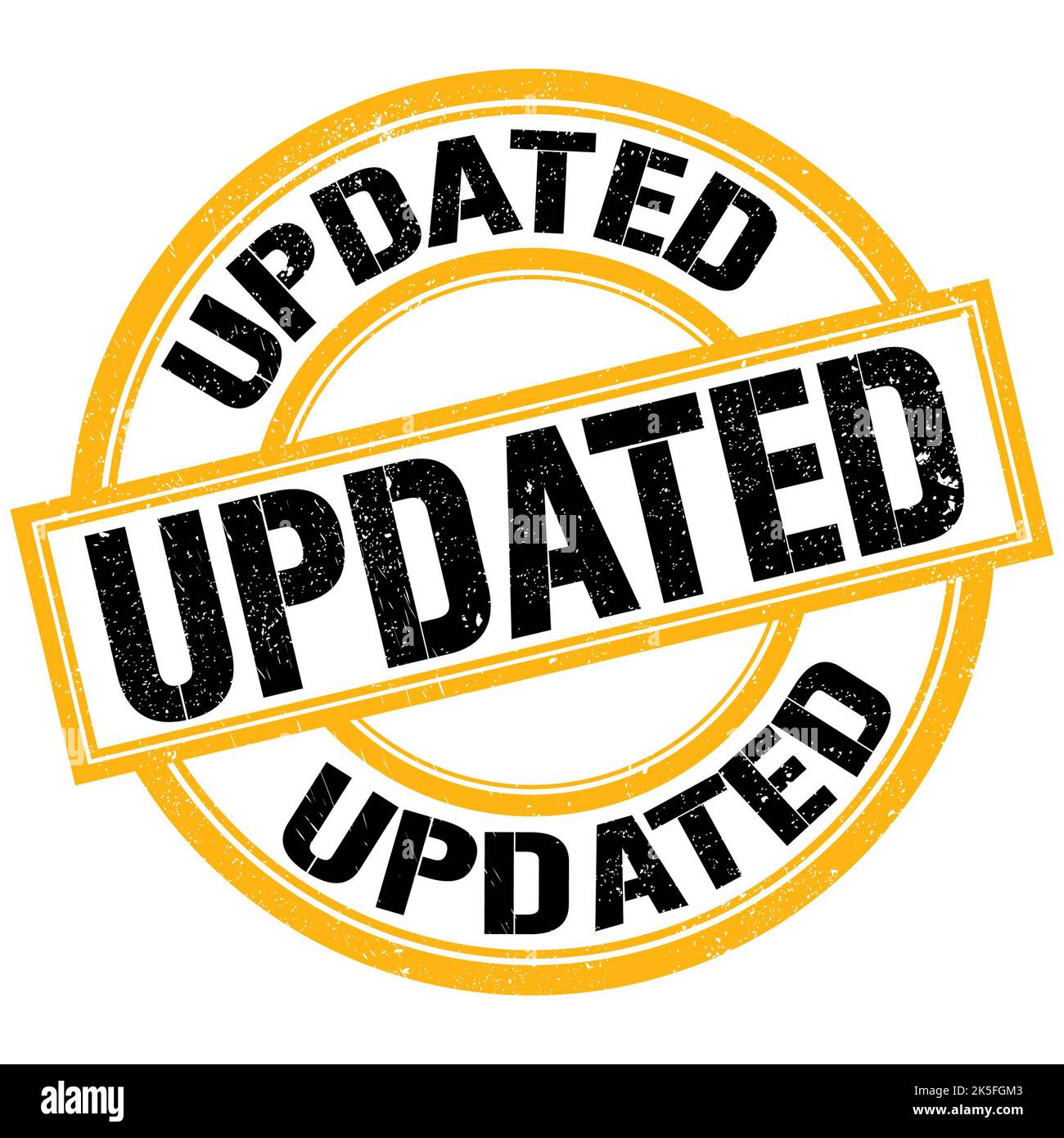 UPDATED text written on yellow-black round stamp sign Stock Photo - Alamy